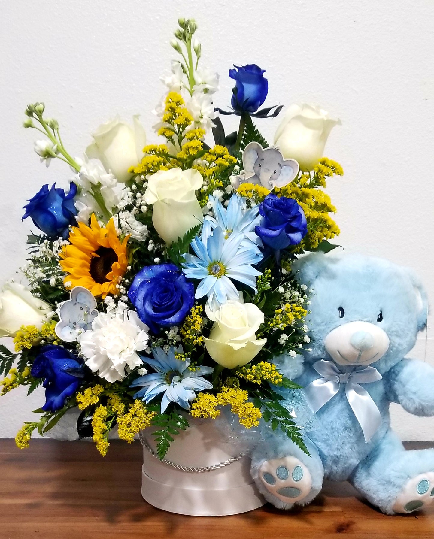 Blue Floral Arrangement with a Plush Bear